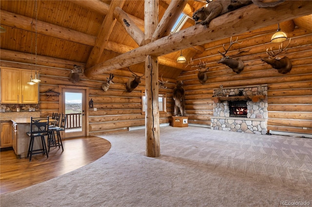 unfurnished living room with carpet, log walls, wood ceiling, a fireplace, and vaulted ceiling with beams