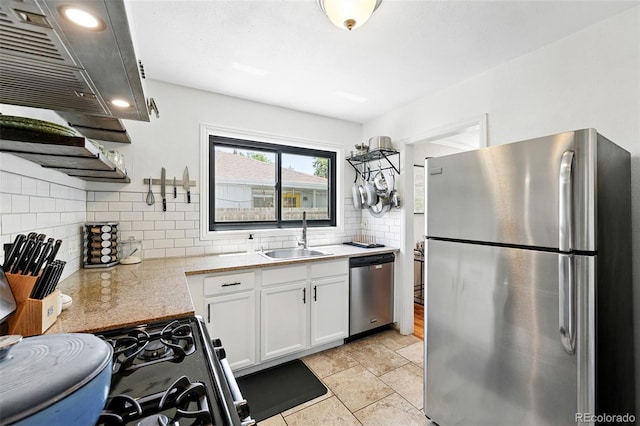 1240 Ulster St, Denver, CO 80220 - kitchen with stainless steel appliances, range hood, white cabinets, and decorative backsplash