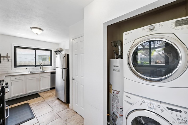 1240 Ulster St, Denver, CO 80220 - laundry room with stacked washing machine and dryer, gas water heater, plenty of natural light, and light tile patterned floors