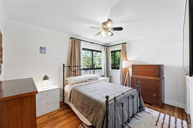 1240 Ulster St, Denver, CO 80220 - bedroom featuring crown molding, wood finished floors, and ceiling fan