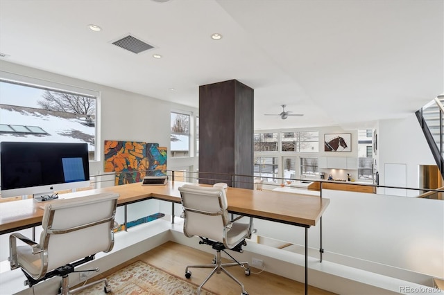 home office with light wood-style flooring, visible vents, and recessed lighting