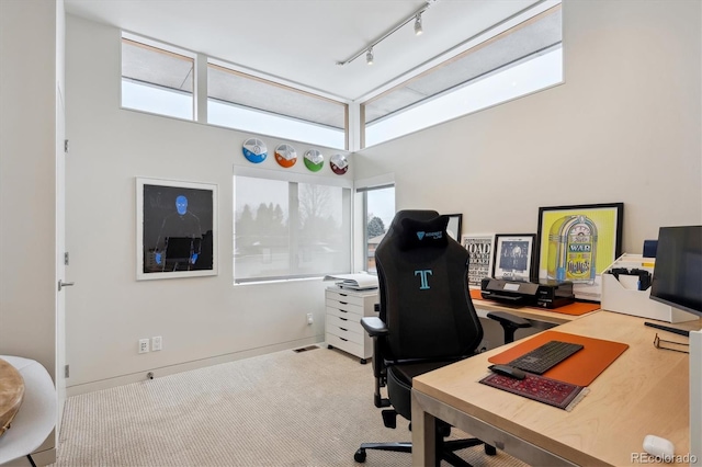 office with light carpet, baseboards, visible vents, and track lighting