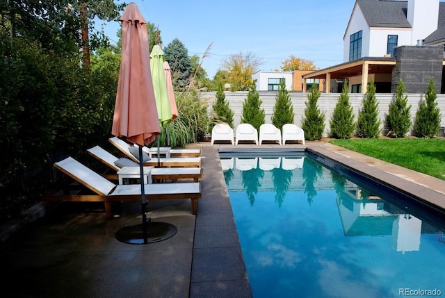 view of pool featuring a fenced in pool, fence, and a patio