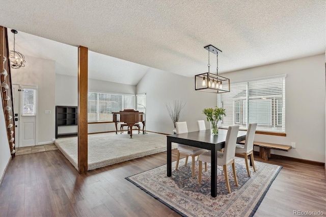 dining area featuring a wealth of natural light, an inviting chandelier, and wood finished floors