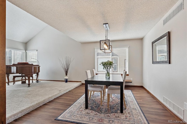 dining area featuring visible vents, baseboards, and dark wood-type flooring