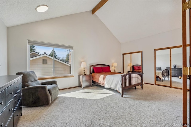 bedroom featuring beam ceiling, carpet, baseboards, and multiple closets