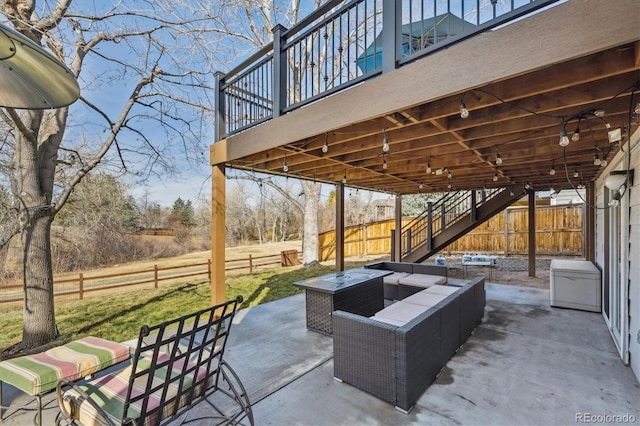 view of patio featuring an outdoor living space with a fire pit, stairs, and fence