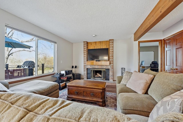 living room with a textured ceiling and a fireplace