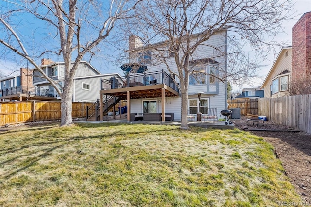 rear view of property with a lawn, a fenced backyard, a wooden deck, central AC unit, and a patio area