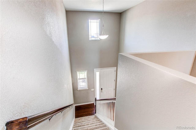 25046 E Bayaud Pl, Aurora, CO 80018 - stairway with plenty of natural light, wood finished floors, and a towering ceiling