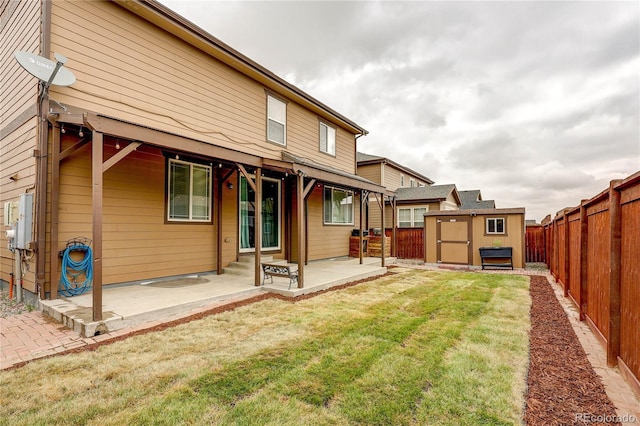 25046 E Bayaud Pl, Aurora, CO 80018 - rear view of house with a patio, a storage unit, and a fenced backyard