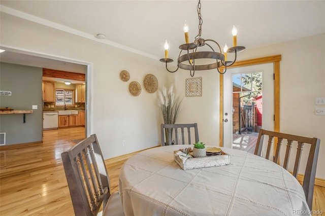 dining space featuring a notable chandelier and light hardwood / wood-style flooring