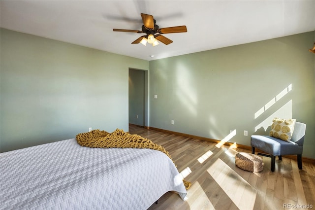 bedroom with ceiling fan and wood-type flooring