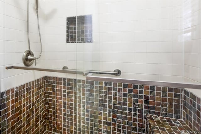 bathroom featuring a shower with door