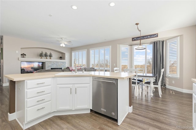 kitchen with white cabinetry, dishwasher, pendant lighting, and a center island with sink