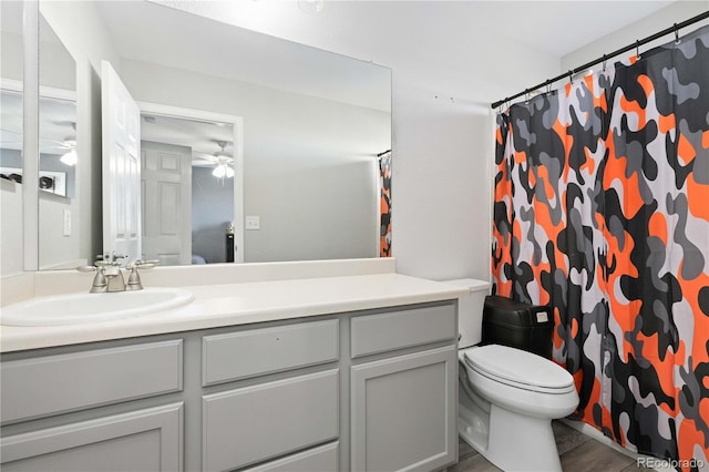 bathroom with ceiling fan, wood-type flooring, toilet, vanity, and a shower with shower curtain