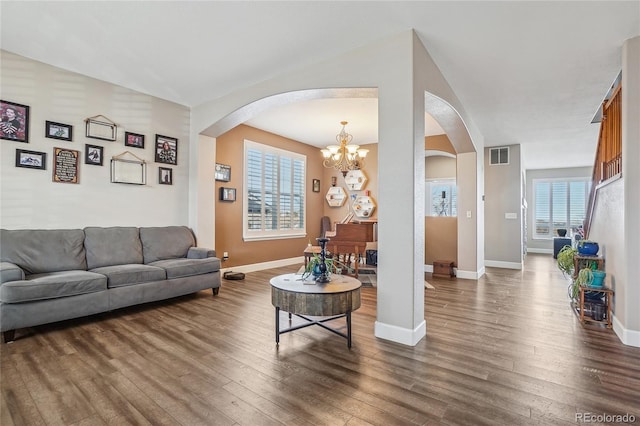 living room featuring dark hardwood / wood-style floors and a chandelier