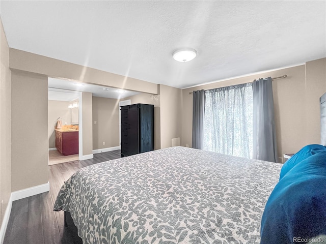 7085 Kiowa Rd, Larkspur, CO 80118 - bedroom with wood finished floors and a textured ceiling