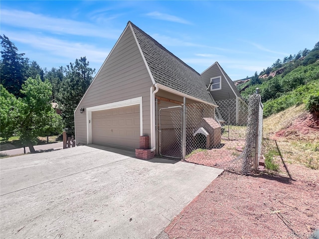 7085 Kiowa Rd, Larkspur, CO 80118 - view of home's exterior with an outbuilding, a garage, and driveway