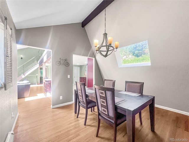 7085 Kiowa Rd, Larkspur, CO 80118 - dining area with baseboard heating, light wood finished floors, a chandelier, beam ceiling, and high vaulted ceiling