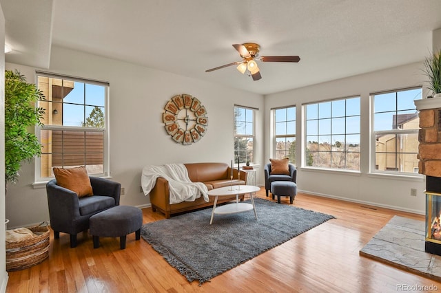 3244 Capstan Way, Colorado Springs, CO 80906 - living room with ceiling fan, a healthy amount of sunlight, and light wood-type flooring