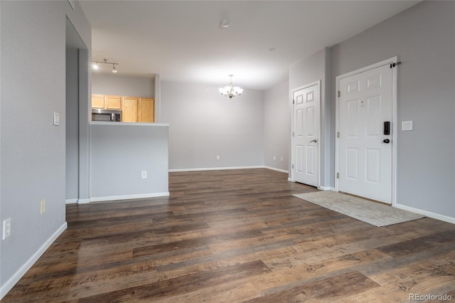 4451 S Ammons St Unit 2-204, Littleton, CO 80123 - unfurnished living room with a chandelier and dark wood finished floors