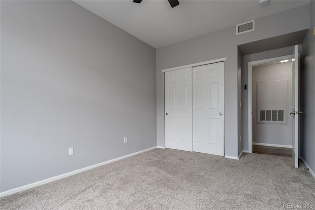 4451 S Ammons St Unit 2-204, Littleton, CO 80123 - unfurnished bedroom featuring carpet floors, a closet, and a ceiling fan