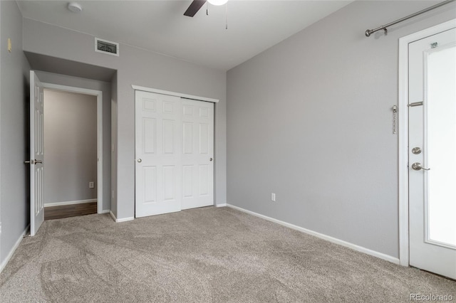 4451 S Ammons St Unit 2-204, Littleton, CO 80123 - unfurnished bedroom featuring carpet flooring, a closet, and a ceiling fan