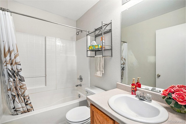 bathroom with shower / tub combo with curtain, toilet, vanity, and a textured wall