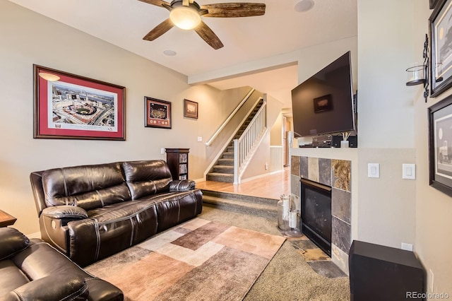 9381 Ashbury Cir Unit 105, Parker, CO 80134 - living area with ceiling fan, a tiled fireplace, and stairs