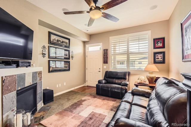 9381 Ashbury Cir Unit 105, Parker, CO 80134 - living area featuring carpet floors, a fireplace, and ceiling fan