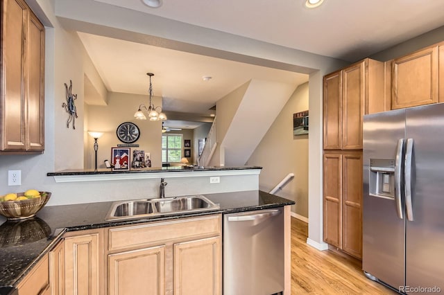 9381 Ashbury Cir Unit 105, Parker, CO 80134 - kitchen featuring stainless steel appliances, light wood-style floors, dark stone countertops, a peninsula, and recessed lighting