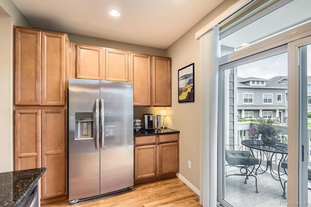 9381 Ashbury Cir Unit 105, Parker, CO 80134 - kitchen with stainless steel fridge, light wood finished floors, dark stone countertops, and recessed lighting