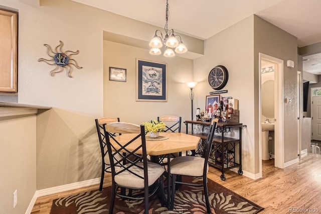 9381 Ashbury Cir Unit 105, Parker, CO 80134 - dining space with light wood-type flooring and a chandelier
