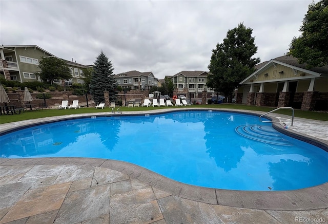 9381 Ashbury Cir Unit 105, Parker, CO 80134 - community pool featuring a residential view and a patio