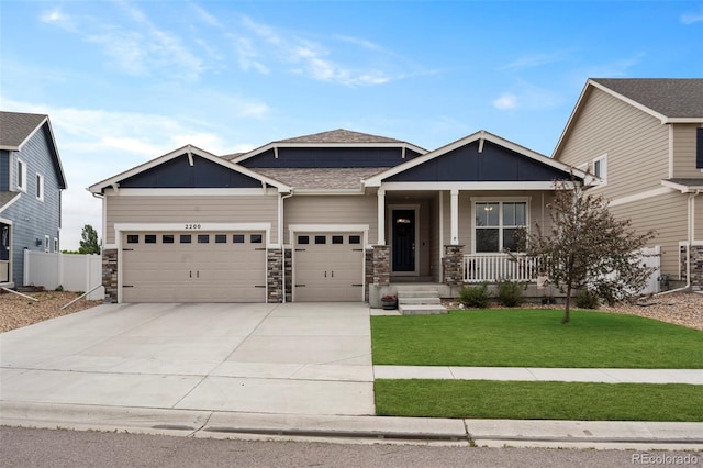 2200 Cadman St, Berthoud, CO 80513 - craftsman house with a garage, a porch, concrete driveway, board and batten siding, and stone siding