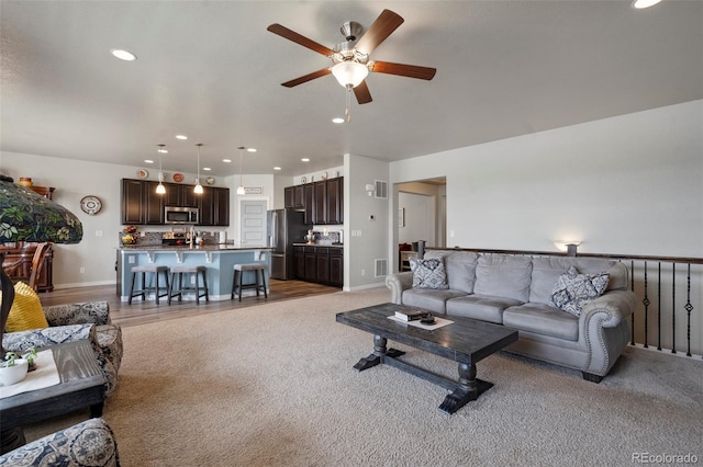 2200 Cadman St, Berthoud, CO 80513 - living room with a ceiling fan, light colored carpet, recessed lighting, and baseboards