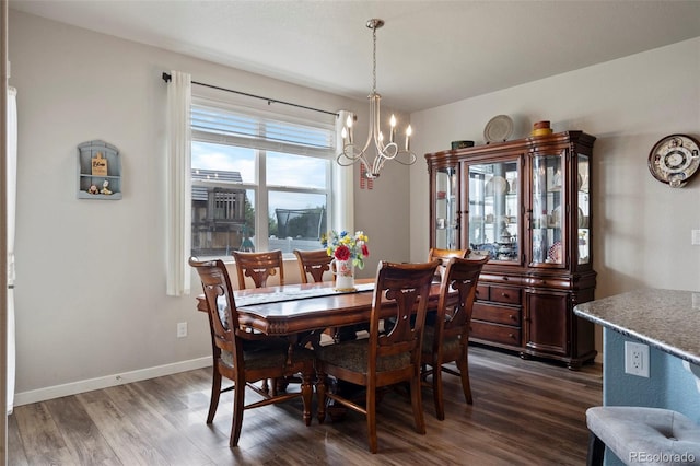 2200 Cadman St, Berthoud, CO 80513 - dining area with a chandelier, dark wood-style flooring, and baseboards