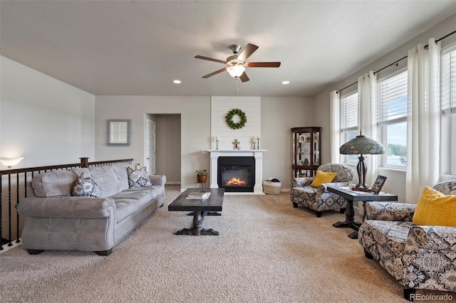 2200 Cadman St, Berthoud, CO 80513 - living area with carpet, a ceiling fan, healthy amount of natural light, recessed lighting, and a large fireplace