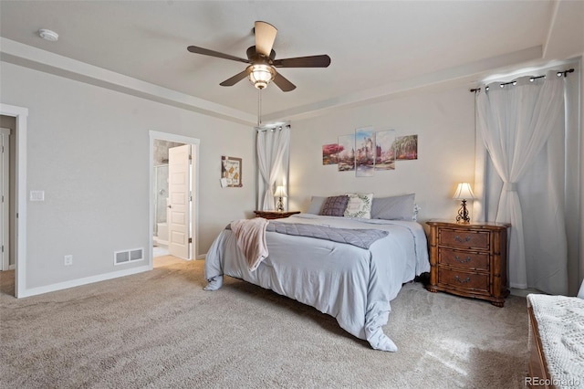 2200 Cadman St, Berthoud, CO 80513 - carpeted bedroom featuring a tray ceiling, baseboards, ensuite bath, and a ceiling fan