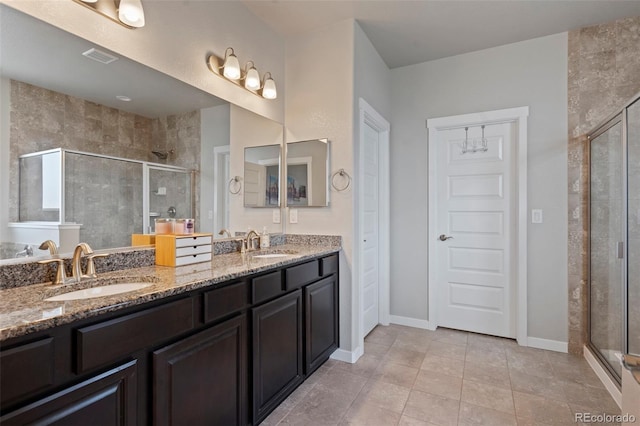 2200 Cadman St, Berthoud, CO 80513 - bathroom featuring a shower stall, double vanity, and tile patterned flooring