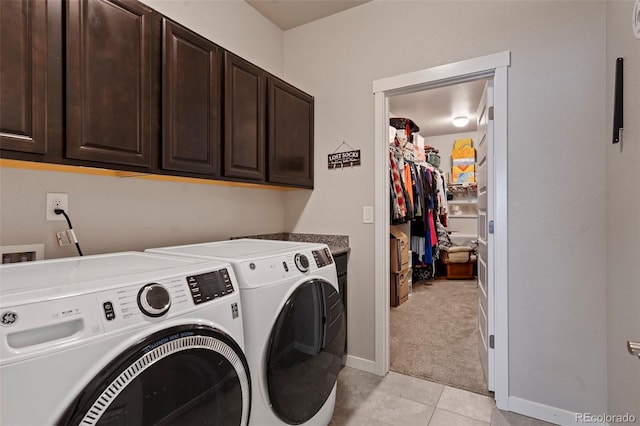 2200 Cadman St, Berthoud, CO 80513 - laundry room with cabinet space, washing machine and dryer, light tile patterned floors, light colored carpet, and baseboards