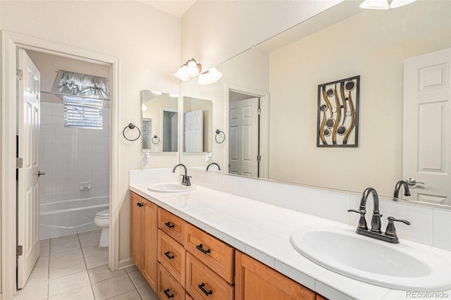 full bathroom with toilet, vanity, tile patterned floors, and tiled shower / bath combo