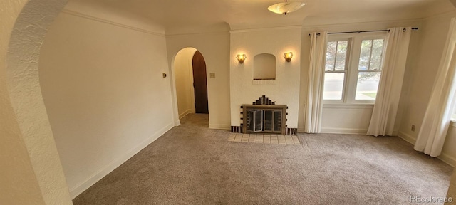 9120 Elm Ct, Denver, CO 80260 - living area with arched walkways, carpet floors, a fireplace, and baseboards