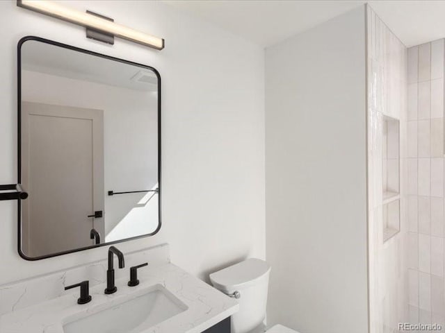 bathroom featuring toilet and vanity