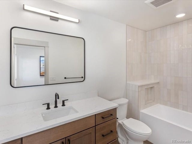 bathroom featuring toilet, visible vents, and vanity