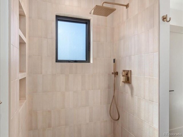 bathroom with tiled shower