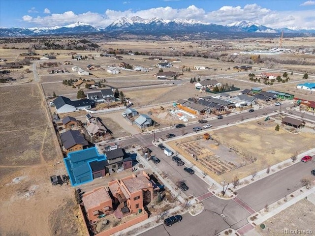 birds eye view of property featuring view of desert and a mountain view