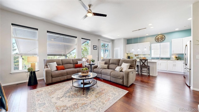 living area with a ceiling fan, dark wood-type flooring, recessed lighting, and baseboards