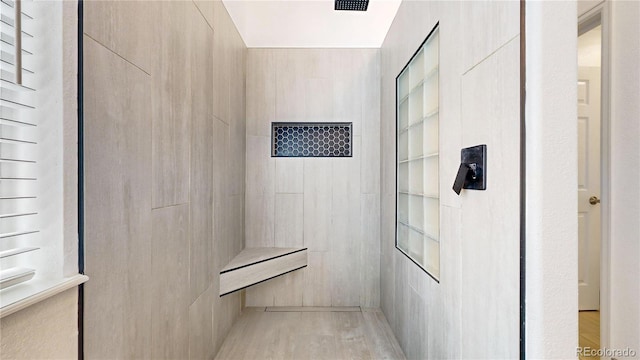 full bath featuring a tile shower
